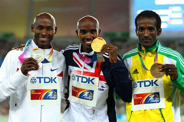  Mohamed Farah of Great Britain celebrates with his gold medal , Bernard Lagat of the USA the silver and Dejen Gebremeskel of Ethiopia the bronze, during the medal ceremony for the men's 5000 metres final  (Getty Images)