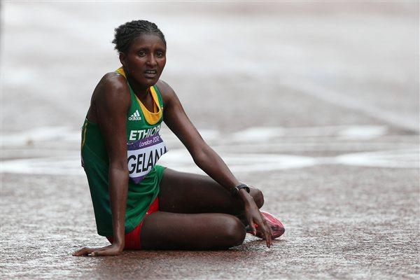Gold medalist Tiki Gelana of Ethiopia rests at the finish line on The Mall after the Women's Marathon on Day 9 of the London 2012 Olympic Games on August 5, 2012 (Getty Images)