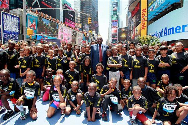 IAAF President Lamine Diack and 100 kids celebrate the IAAF Centenary in New York's  Times Square (Victah Sailer)