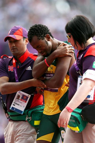 Ofentse Mogawane of South Africa receives treatment during the Men's 4 x 400m Relay Round 1 heats on Day 13 of the London 2012 Olympic Games at Olympic Stadium on August 9, 2012 (Getty Images)