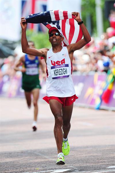 Mebrahtom Keflezighi of the United States holds the United States' national flag aloft as he approaches the finish line in the Men's Marathon  of the London 2012 Olympic Games. (Getty Images)