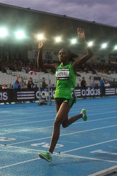 Joyce Chepkirui of Kenya celebrates as she crosses the finish line to win the Zatopek 10 Women's 10,000m during the 2011 Zatopek Classic (Getty Images)
