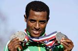Kenenisa Bekele shows off his four gold medal haul (Getty Images)