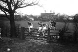 March 1913: Competitors in the English National Cross Country Championships climbing over a gate on the route (Topical Press Agency/Getty Images)