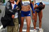 Alina Adriana Istudora is given help by an official after the World Half Marathon in Birmingham (Getty Images)