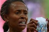 Meseret Defar of Ethiopia holds up a picture as she won the gold medal in the Women's 5000m Final on Day 14 of the London 2012 Olympic Games on 10 August 2012 (Getty Images)